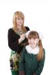 Mom is brushing young schoolgirl`s hair.