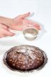 Chocolate cake and sieve in hands