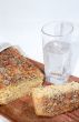 Cutting bread and glass of mineral water close up