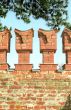 Merlons of red brick wall