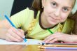 Girl holding a blue pencil