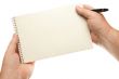 Male Hands Holding Pen and Pad of Paper