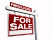 Red Foreclosure Real Estate Sign on White.