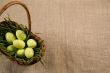 Basket with Easter eggs in grass