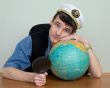 Man in uniform cap with globe