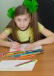 Girl drawing sitting at a table