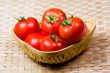 Tomato basket with bamboo mat background