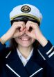 Funny girl in a sea uniform emits binoculars