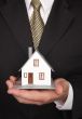 Businessman Holding House