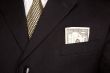 Dollar Bill in Businessman`s Coat Pocket