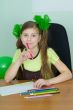 Girl sitting at a table with pencils