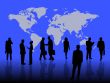 business people in front of a world map