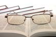 Eyeglasses on college books wisdom