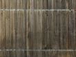 Old wooden fence with metal flat bar