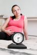 Pregnant woman and clock