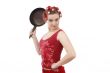 Housewife with curlers, holding a frying pan.