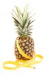 fresh pineapple with tape measure isolated on white background