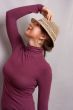 girl in bright hat standing half-face