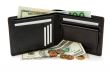 Black wallet, banknotes and coins isolated