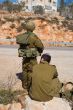 Israeli soldiers patrol in palestinian village