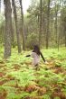 woman through fern field