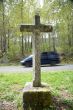 stone cross with car