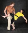 Couple dancing a tango on a black