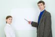 Teacher explains something to the schoolgirl