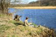 Fisherman sitting on the river shore