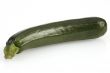 single zucchini or courgette on white