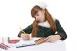 Schoolgirl is painting in bright colours pencils.