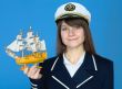 Portrait of the woman in a sea cap with the ship