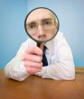 Man with a magnifier in a hand