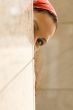 woman looking behind a wall