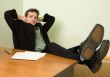 Boss in black suit on a workplace