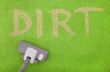vacuuming dirt off a green carpet