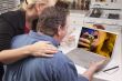 Couple In Kitchen Using Laptop - Music Entertainment