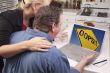 Couple In Kitchen Using Laptop - Oops! Sign