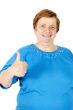 elderly woman is putting her thumb up on white