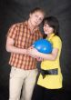 Pair holds on hands a ballon as the baby