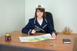 Girl in the form of sea captain at office