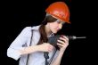 Young woman in a protective helmet with a drill