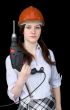 Beautiful girl in a protective helmet with a drill