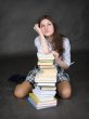 Girl sits having leant the elbows on a books