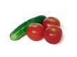 Fresh tomatoes with cucumbers are isolated on the white