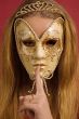 young woman in mask shows gesture of silence