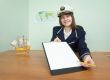 Girl in a sea uniform at office with tablet