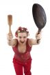 Housewife with curlers  holding a frying pan.