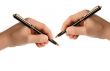 Lefthanded child writing on white paper