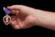 Man Holding Purple Heart War Medal